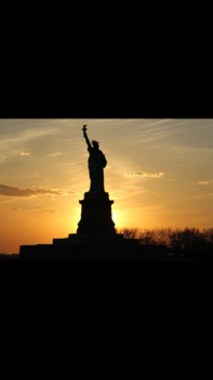 New York - Sunset behind the statue of Liberty
